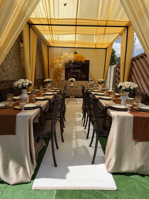 Gold canopy picnic setup with a long table and floral centerpieces — Harare event decor by Triumphant Events