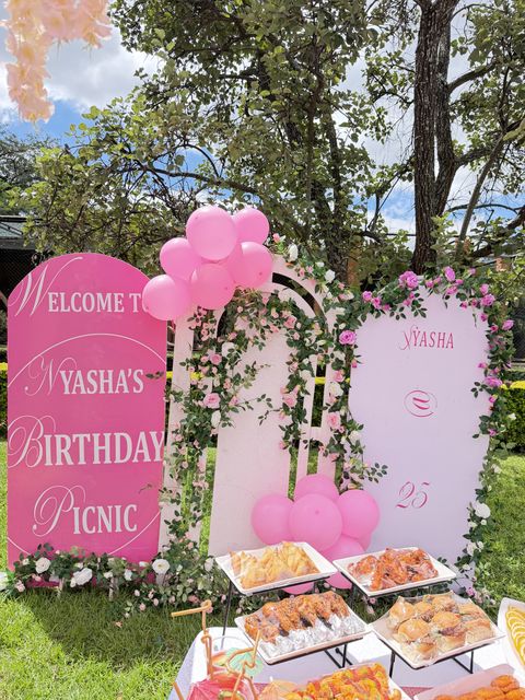 "Welcome to Nyasha's Birthday Picnic" sign with pink balloons, by Triumphant Events