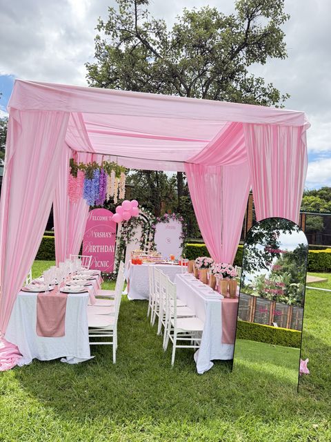 Pink canopy garden picnic with a mirror welcome sign, by Triumphant Events