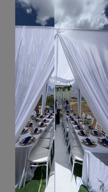 Mirror-reflected view down a white-draped tent aisle with table settings on both sides, by Triumphant Events